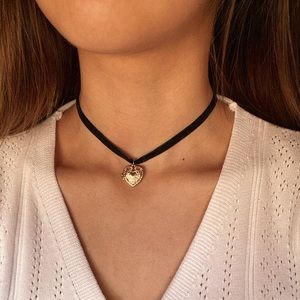 black choker with gold heart pendant